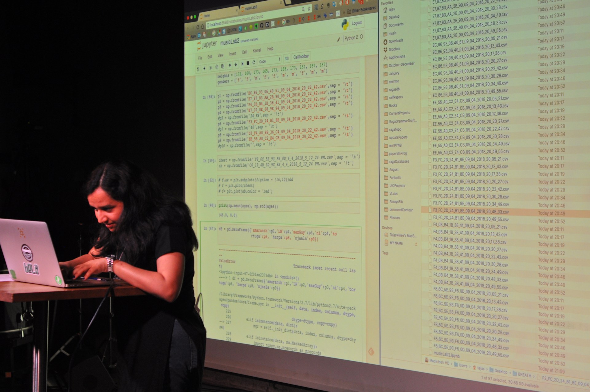 A researcher analysing data live, with code projected on a screen