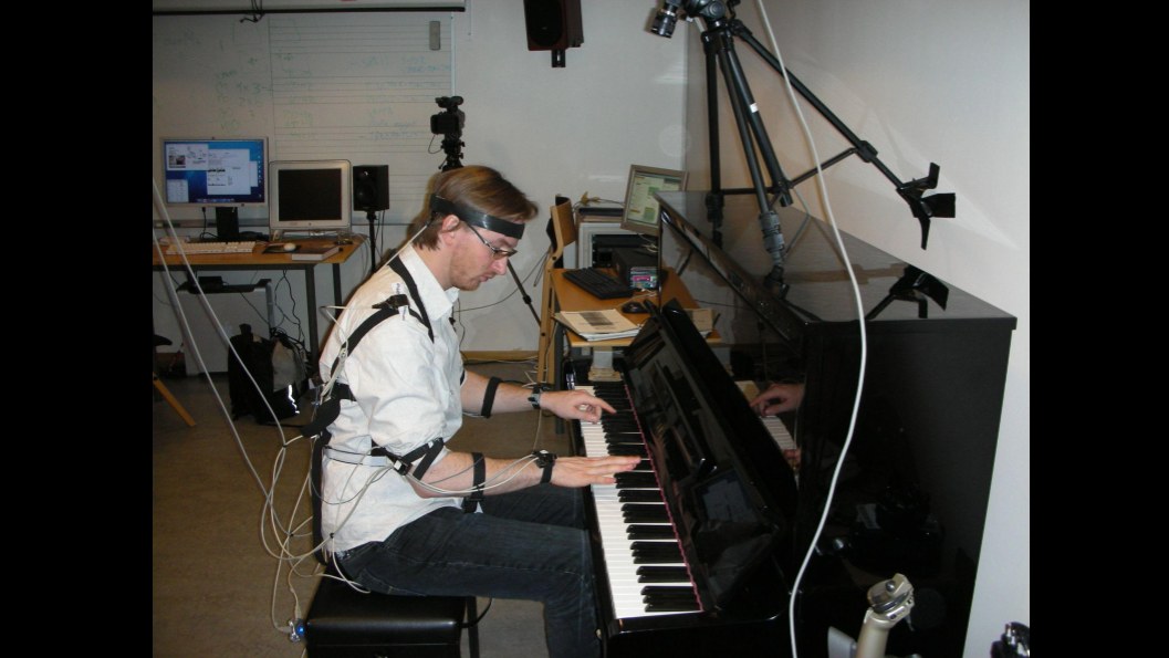 A pianist with motion capture markers in a course